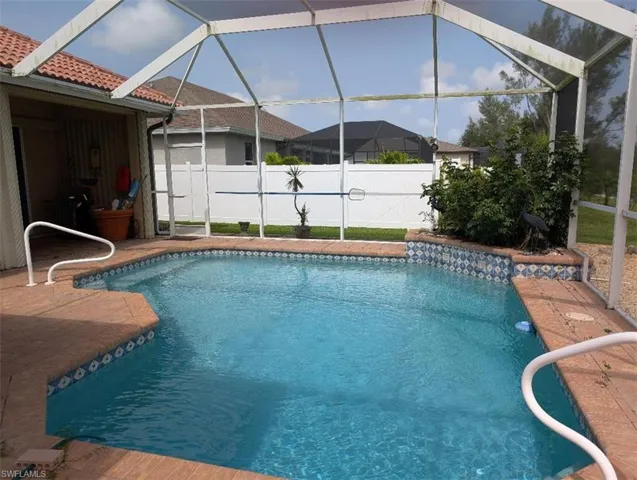View of swimming pool with a lanai
