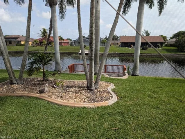 View of grassy yard with a water view and a residential view