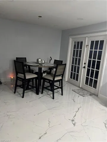 Dining area with french doors and baseboards
