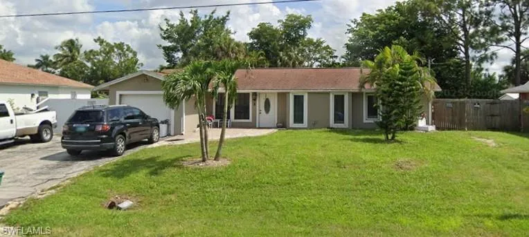 Single story home featuring an attached garage, driveway, and stucco siding