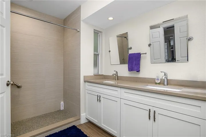 Bathroom with a tile shower and a sink