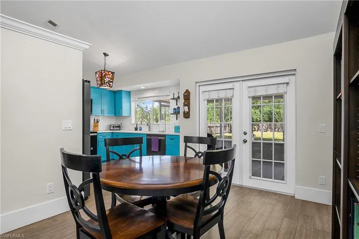 Dining area featuring french doors, visible vents, light wood finished floors, and plenty of natural light