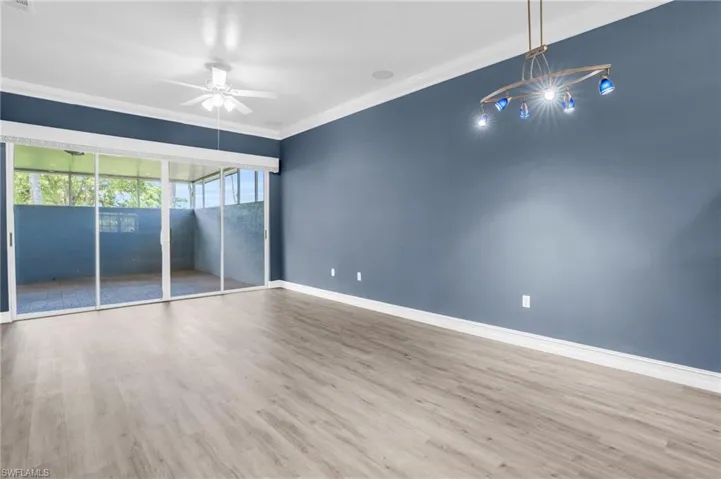 Unfurnished room with hardwood / wood-style flooring, ornamental molding, and ceiling fan