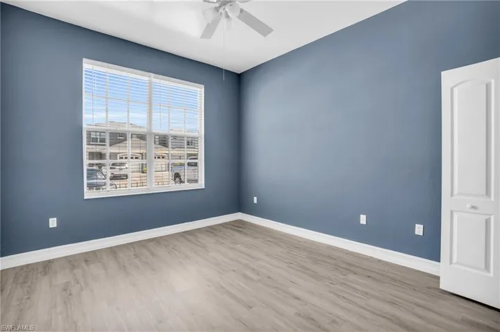 Empty room with hardwood / wood-style flooring and ceiling fan