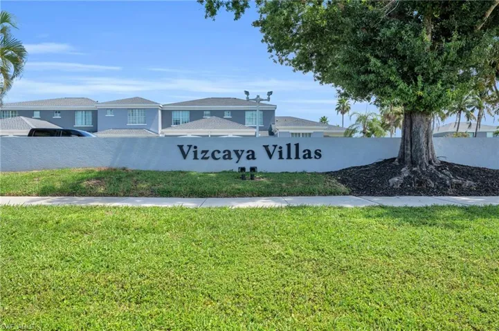 Community / neighborhood sign with a yard