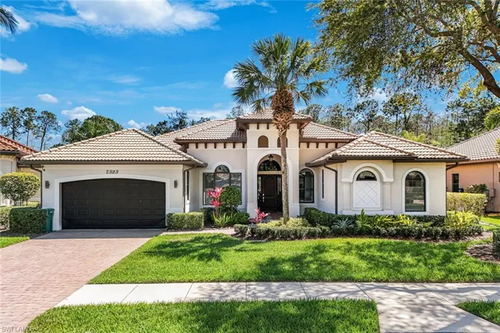 Mediterranean / spanish-style home with stucco siding, an attached garage, decorative driveway, and a front yard