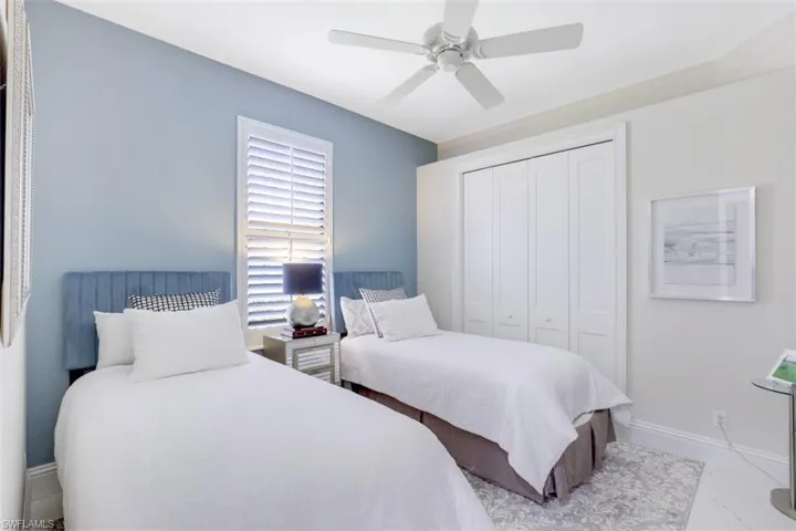 Bedroom featuring a large closet, ceiling fan, and tile flooring