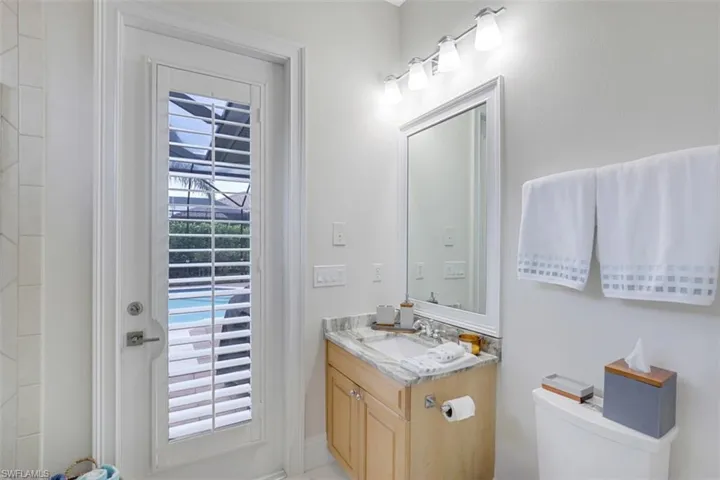 3rd pool bath with vanity, toilet and shower with access to office/bedroom and pool area.