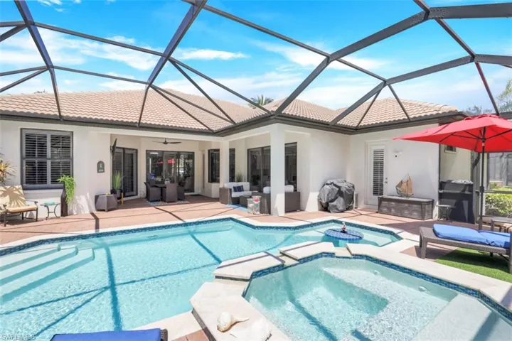 Remodeled pool/hot tub featuring screened enclosure, an outdoor living space and a new outdoor kitchen (not shown).