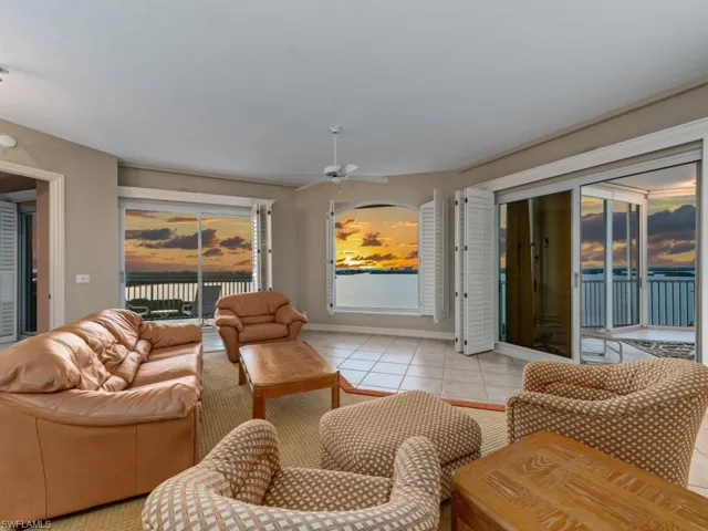 Living room featuring ceiling fan and light tile patterned flooring