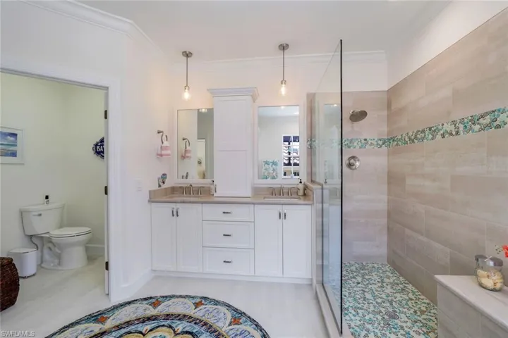 Dual comfort height vanities, walk in shower, private water closet.
