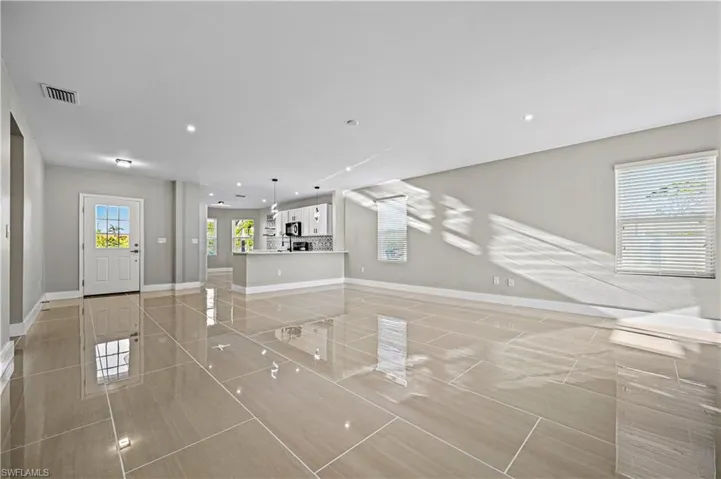 Unfurnished living room with recessed lighting, baseboards, and visible vents