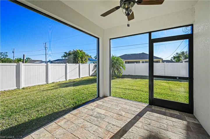 Unfurnished sunroom featuring a wealth of natural light and a ceiling fan