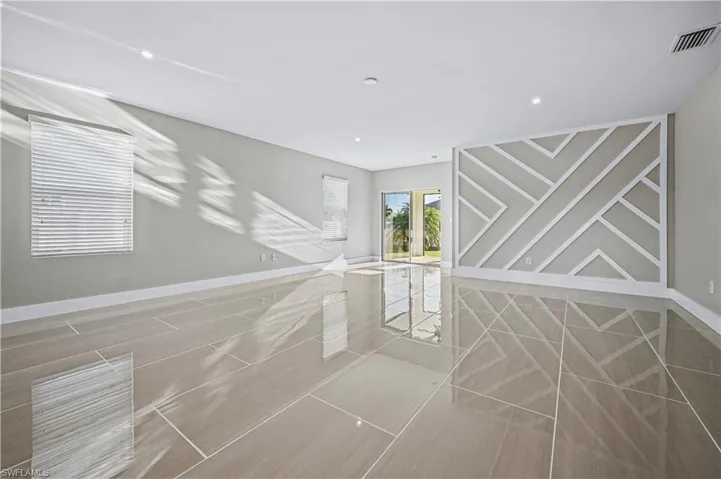 Unfurnished room with visible vents and baseboards