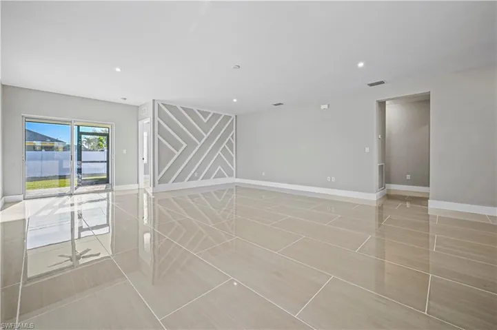 Empty room with recessed lighting, visible vents, and baseboards