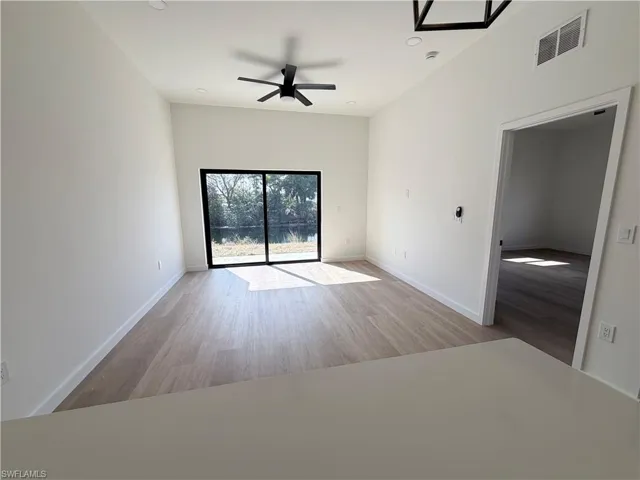 Unfurnished room with ceiling fan, light wood-type flooring, and recessed lighting