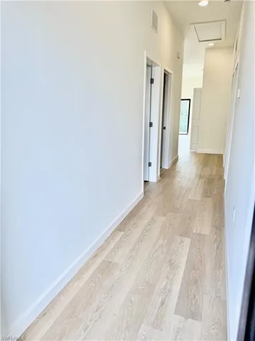 Hallway featuring light wood-style floors and recessed lighting