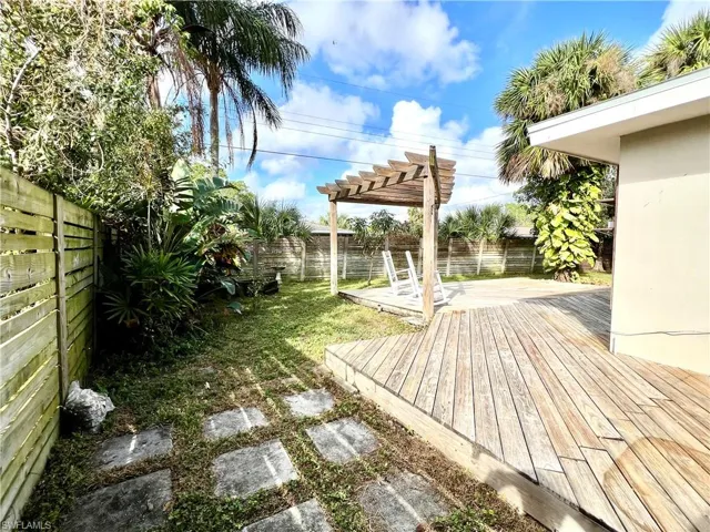 View of yard featuring a pergola and a deck