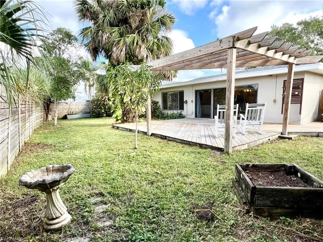 View of yard featuring a pergola and a wooden deck