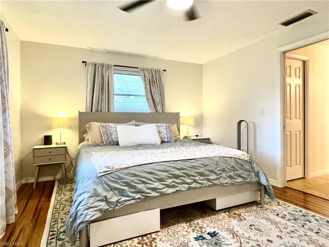 Bedroom with hardwood / wood-style floors and ceiling fan
