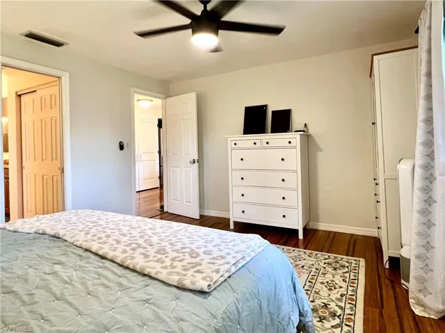 Bedroom featuring ceiling fan and dark hardwood / wood-style flooring