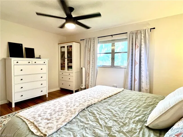 Bedroom featuring ceiling fan and dark hardwood / wood-style flooring