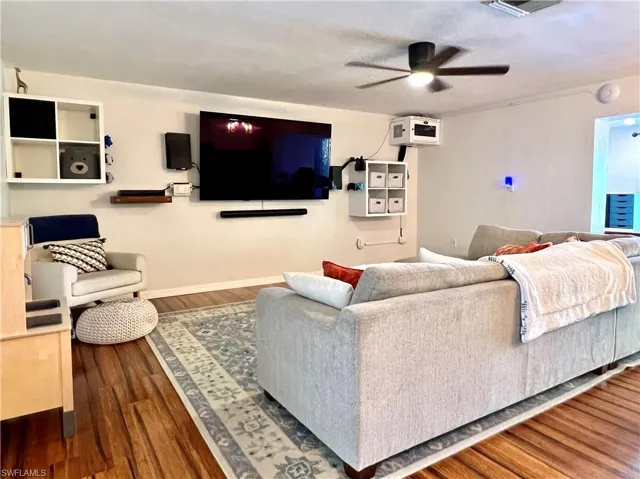 Living room featuring hardwood / wood-style flooring and ceiling fan