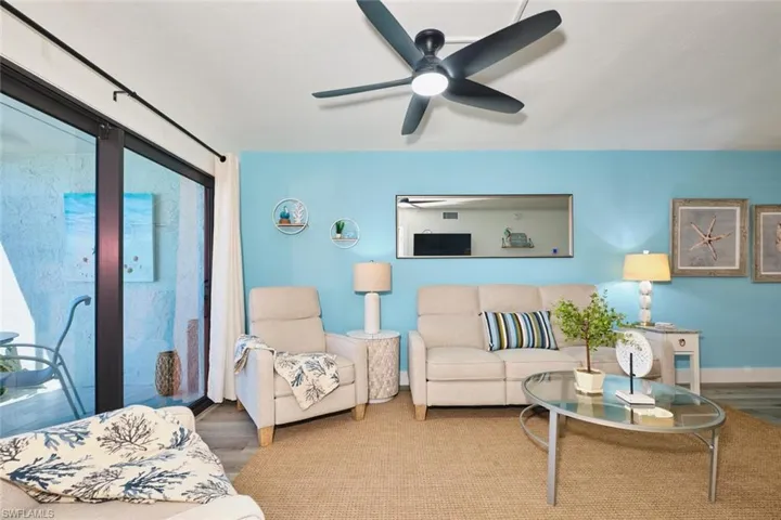 Living area with wood finished floors and ceiling fan