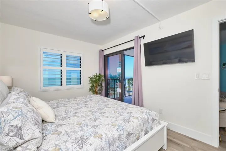 Bedroom featuring access to exterior and light wood-style floors