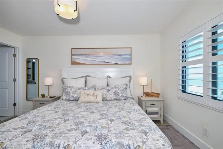 Carpeted bedroom featuring baseboards