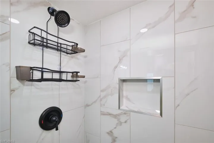 Bathroom view of a marble finish shower