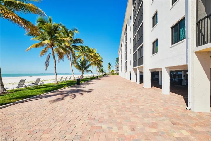 View of property's community featuring view of water and beach