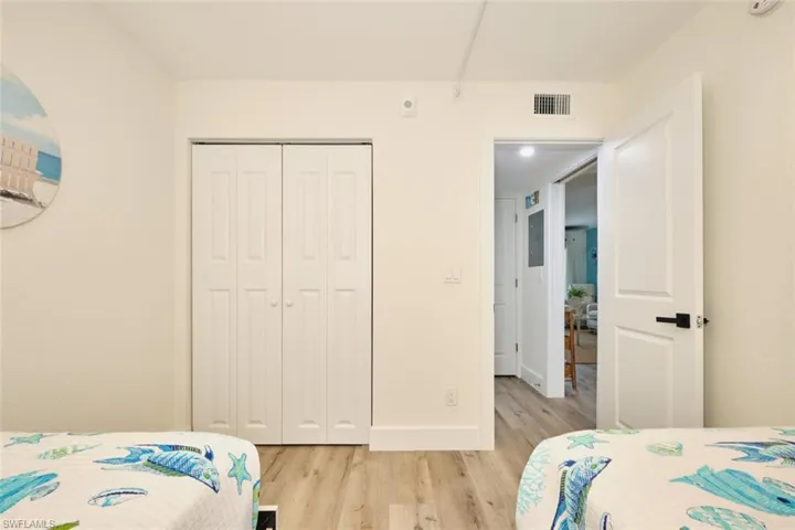 Bedroom featuring light wood-style flooring and a closet