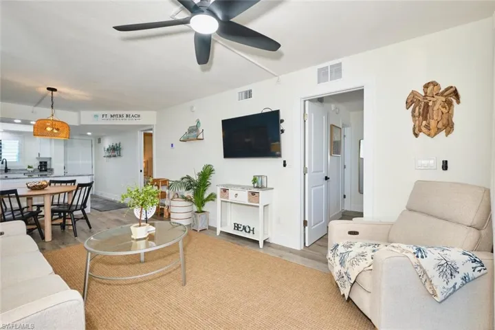 Living area with light wood-style floors and ceiling fan