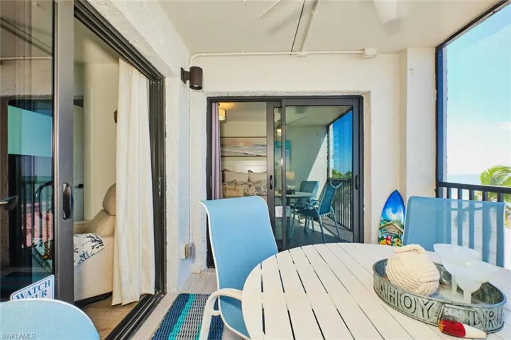 Balcony featuring outdoor dining space and ceiling fan