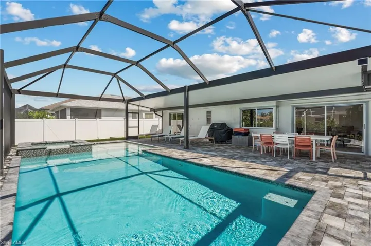 View of swimming pool with a patio, an in ground hot tub, and  paver patio
