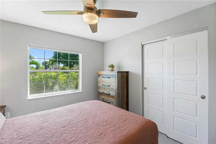 Guest Bedroom featuring ceiling fan, tile flooring, and a closet