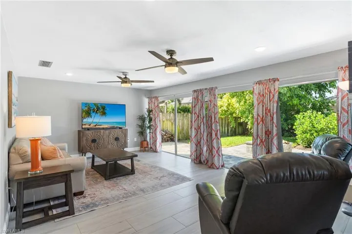 Living room featuring ceiling fan and tile flooring