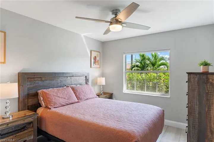 Guest Bedroom with ceiling fan and light tile flooring