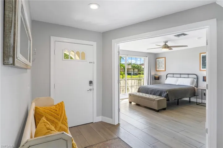 Bedroom featuring ceiling fan, access to exterior, and light tile  floors