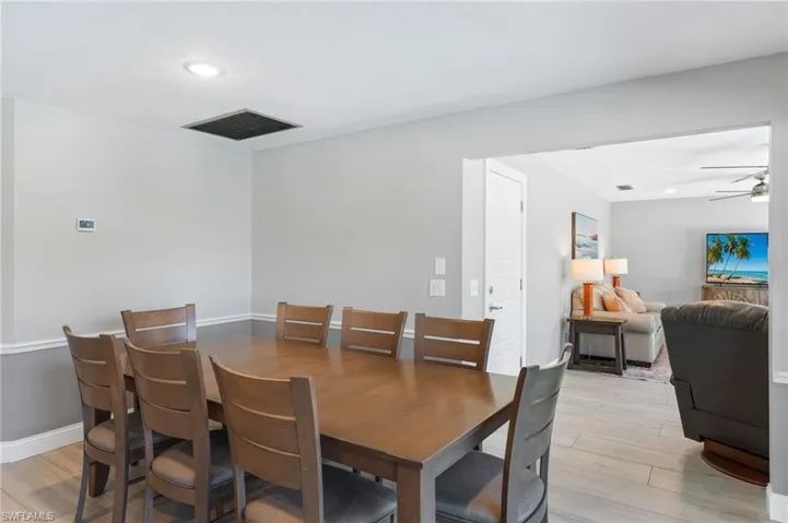 Dining room with light  tile flooring and ceiling fan