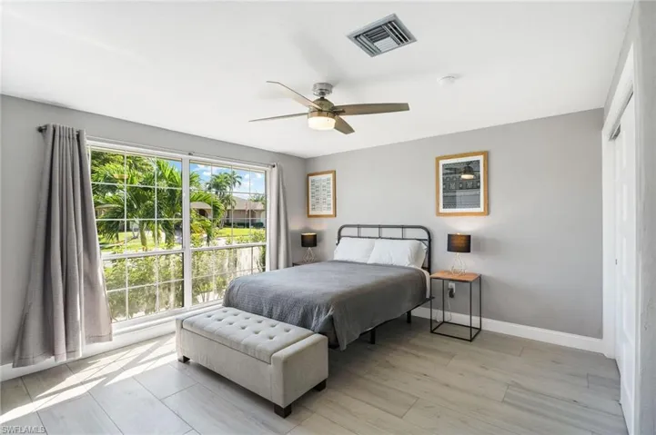 Guest Bedroom with ceiling fan and light tile flooring