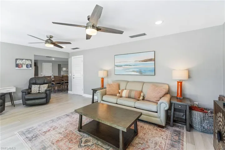 Living room with ceiling fan and tile flooring