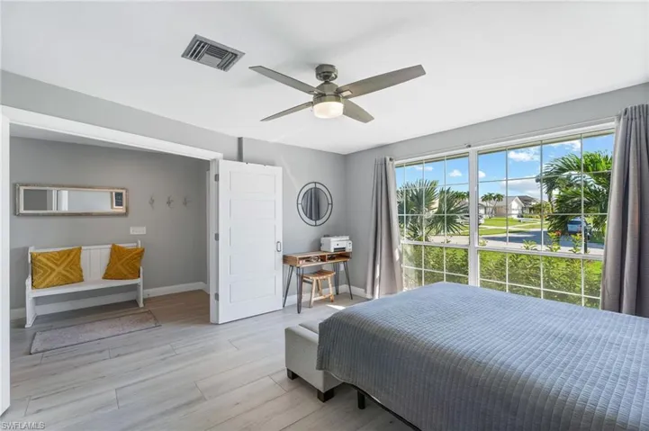 Guest Bedroom with ceiling fan and light tile flooring