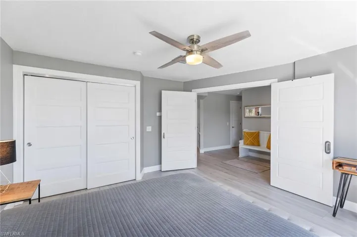 Guest Bedroom with ceiling fan, a closet, and light tile flooring