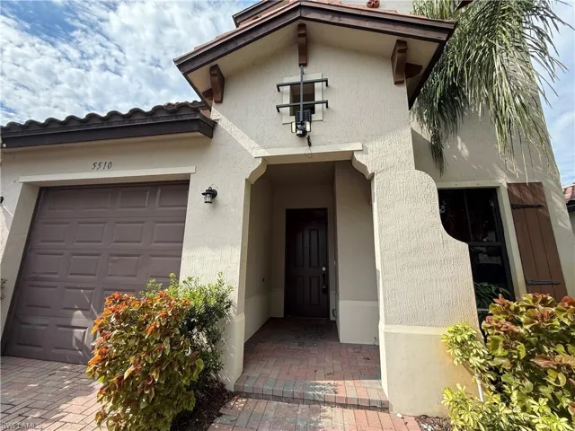 Entrance to property featuring stucco siding and a garage