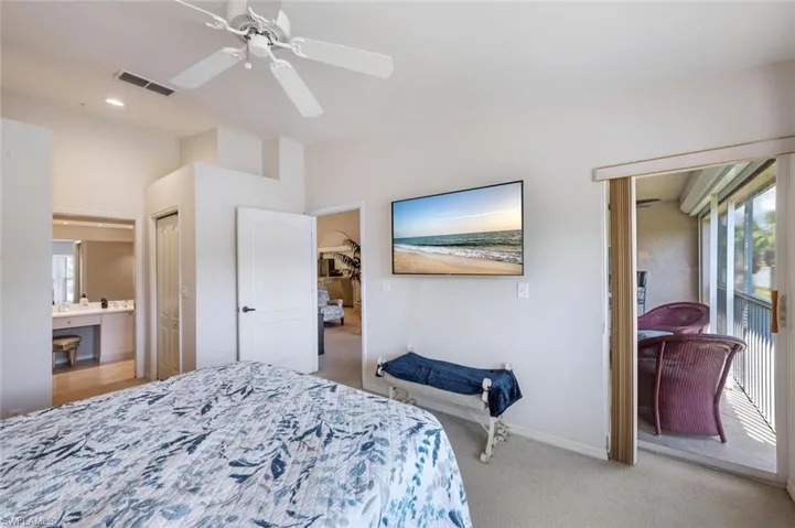 Bedroom with ensuite bath, light colored carpet, visible vents, ceiling fan, and recessed lighting