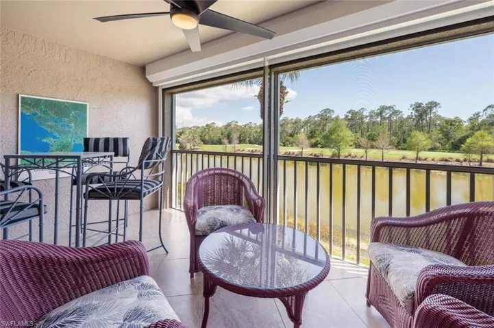 Sunroom / solarium featuring a water view