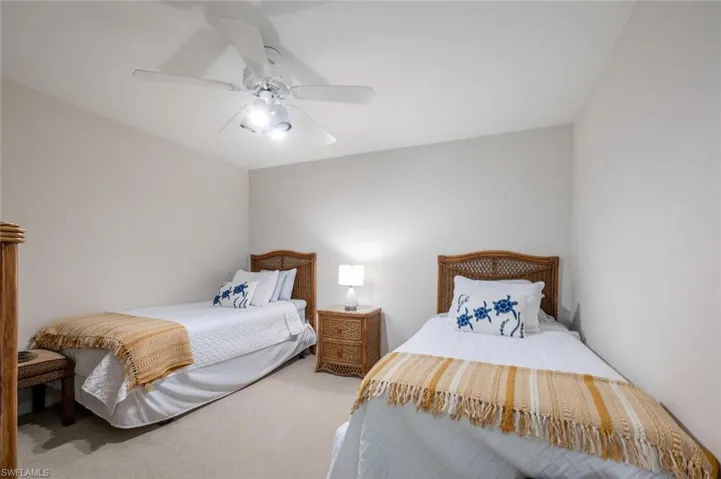 Carpeted bedroom with ceiling fan