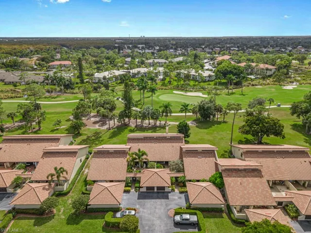 Aerial perspective of suburban area featuring a golf course